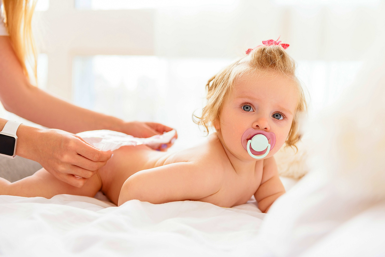 Adorable Blonde Baby Girl Getting Her Diaper Changed
